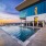 44th-floor pool deck with lounge chairs, cabanas and a panoramic skyline view through glass walls
