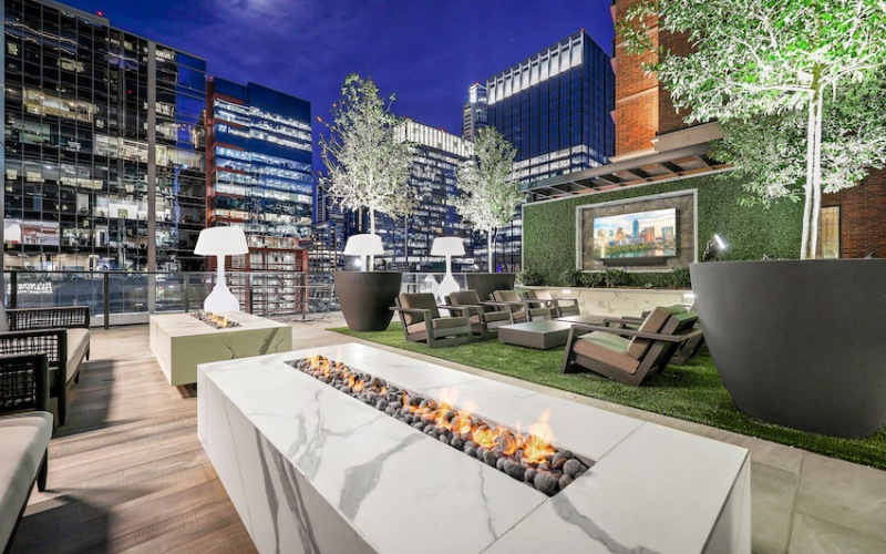 outdoor fire place with tv and lamps