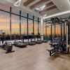 45th Floor Fitness Center with floor to ceiling windows, weight machines, dumbbells, and cardio equipment