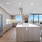 kitchen photo with white quartz countertops, beige wood cabinets, brown wood flooring 