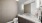 Powder bathroom photo with title backsplash, dark cabinets, and white countertop