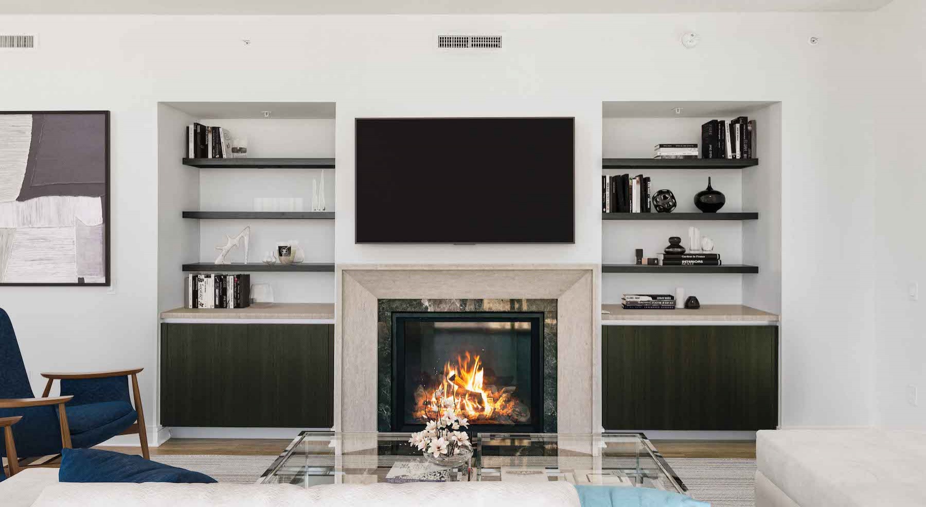 Spacious well lit living room with large floor to ceiling windows 